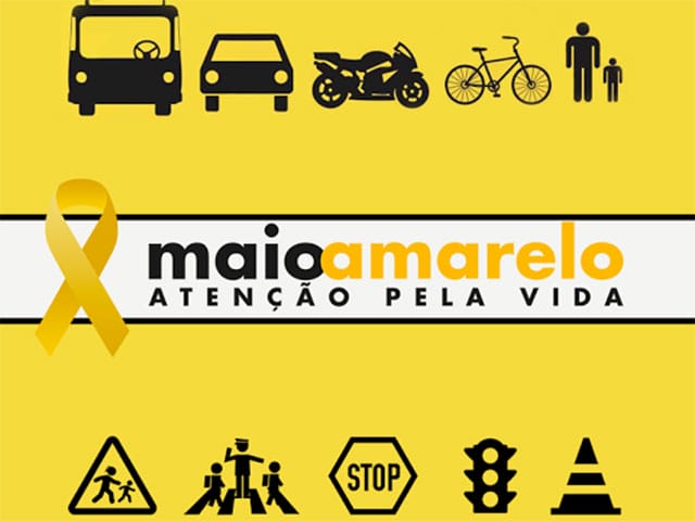 Fondo amarillo con una cinta de sensibilización y varios iconos de seguridad vial, entre ellos vehículos, una bicicleta y un peatón, con el texto "maio amarelo atenção pela vida".